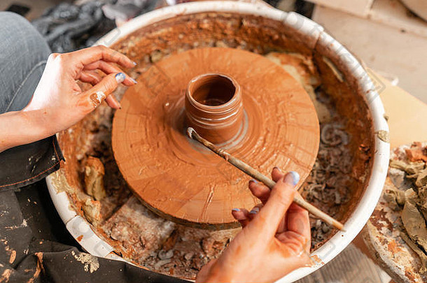 工匠手使陶器碗女人工作波特轮家庭业务商店造型能粘土视图前
