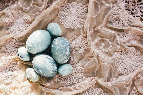木制质朴面料上的时尚复活节彩蛋，俯视图。现代复活节彩蛋用灰色大理石色的天然染料绘制。复活节快乐，欢迎你
