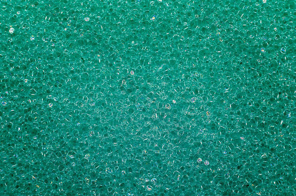 显示材料结构的绿色洗碗海绵的极端宏观照片。