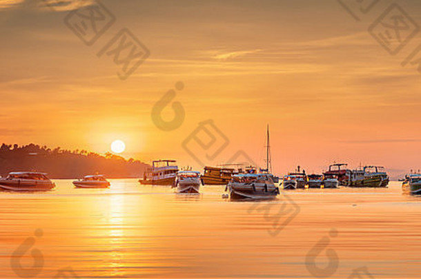 美丽的日出图片，五颜六色的天空和热带海滩上的船只。泰国