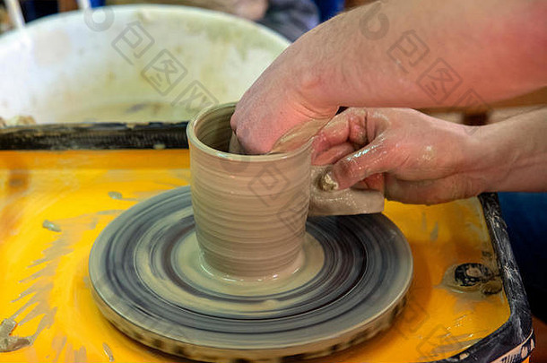 关于用陶工的轮子制作陶瓷壶的<strong>硕士班</strong>。陶器正在绕轴线旋转。