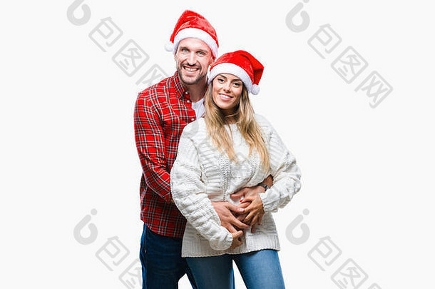 这对相爱的年轻夫妇戴着圣诞帽，脸上带着快乐而冷静的微笑。幸运儿。