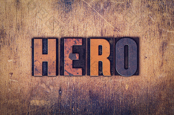 “英雄”一词是在一个陈旧的木制背景上用肮脏的老式活版印刷字体写的。