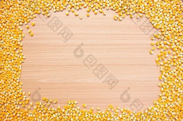 由木料上的生玉米颗粒制成的框架。文本、数字或图标的空白。白色b上分离的爆米花框架和边缘用生玉米粒