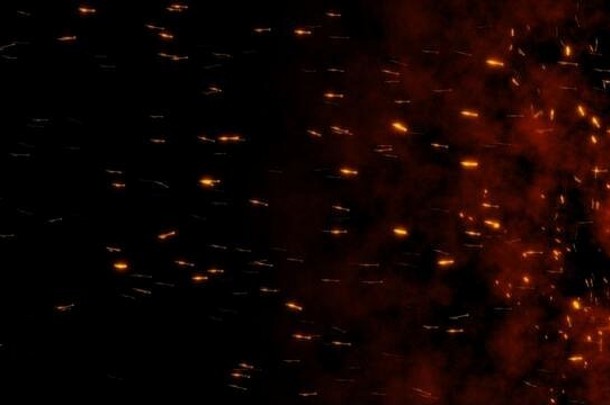 燃烧着的炽热的火花从右到左在夜空中飞溅。美丽的抽象背景黑色背景上的飞翼形状。像个傻瓜