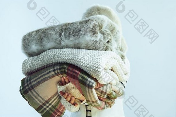 时尚的年女人白色条纹毛衣围巾耳朵皮瓣他持有堆栈毯子孤立的冬天光蓝色的背景