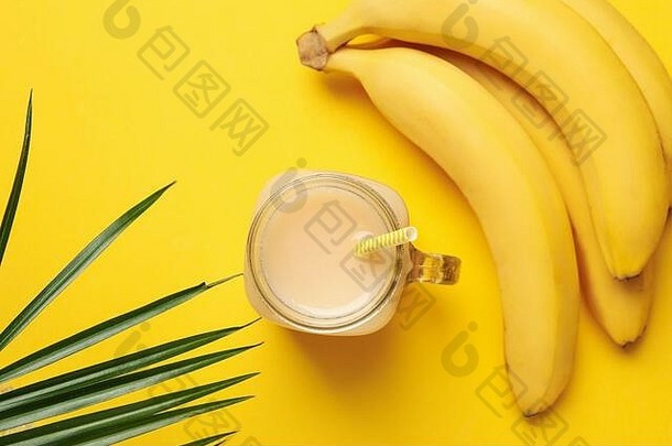 黄色背景上的香蕉和果汁。新鲜水果