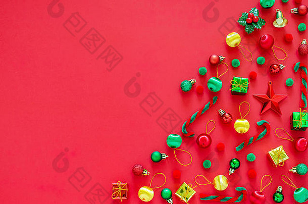 圣诞树由红色背景上的新年装饰品制成。平铺最小假日概念。