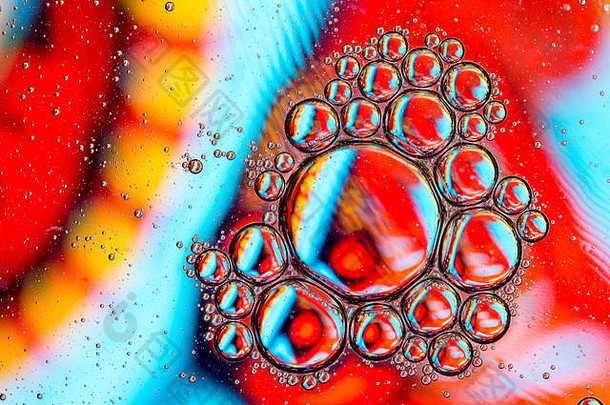彩色背景下水面上植物油滴/气泡特写细节的抽象背景