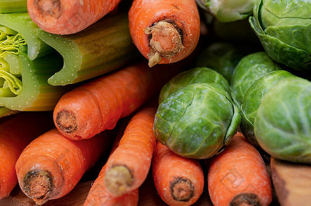各种新鲜生有机蔬菜，包括芹菜茎、胡萝卜、卷心菜。