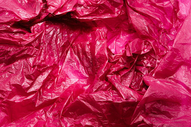 红色塑料袋质地。塑料垃圾的皱褶背景
