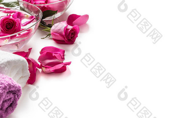 粉色玫瑰花瓣放在碗里，用毛巾和纯水抹在白色的上面。。水疗与健康概念