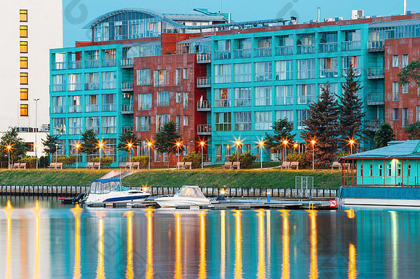 拉脱维亚里加。傍晚的老建筑在夏日黄昏照亮了Dauga河的堤岸和码头。