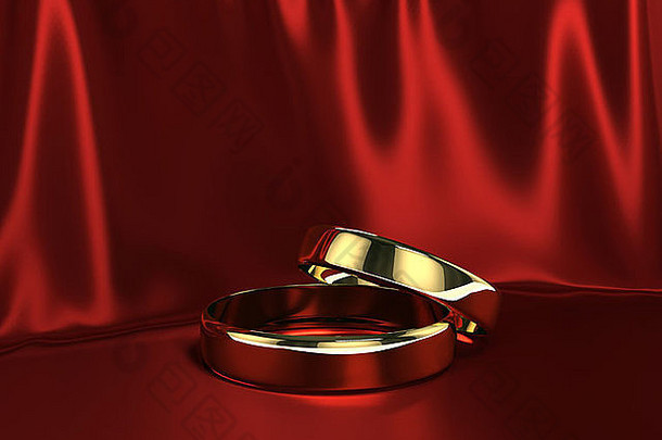红色丝绸背景上的两枚金戒指