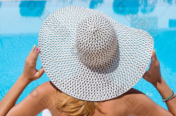 游泳池边戴帽子的女人。暑假时间