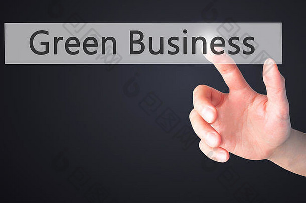 绿色业务-手动按下模糊背景上的按钮。商业、技术、互联网概念。库存照片