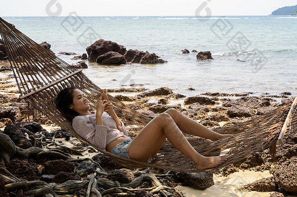 年轻的美丽的亚洲旅游女人放松海滩