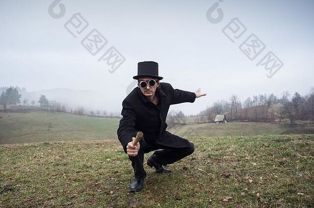 表演，一个在草地上戴圆柱帽的男人