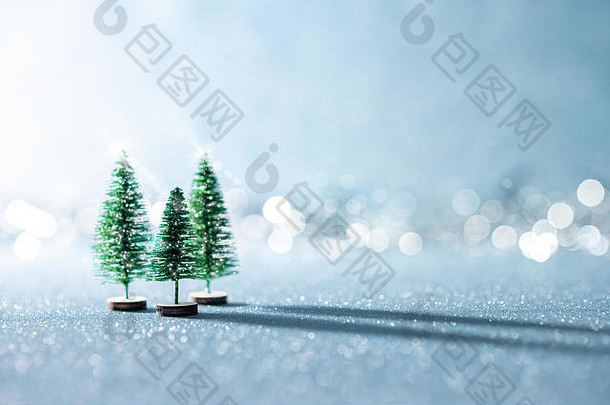 神奇的微型冬天仙境背景常绿圣诞节树闪亮的蓝色的背景散景