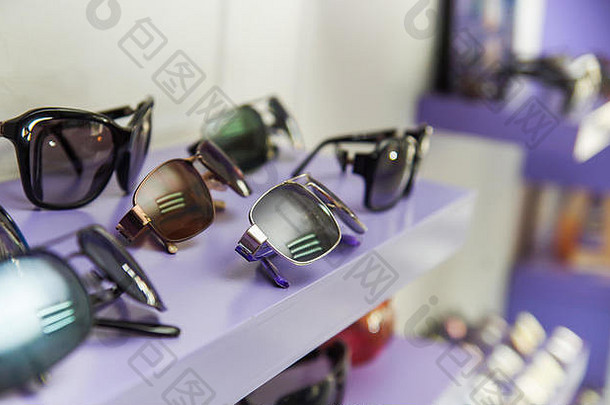在一个模糊的背景下，在紫色橱窗内的眼镜店里，各种美丽眼镜的特写镜头