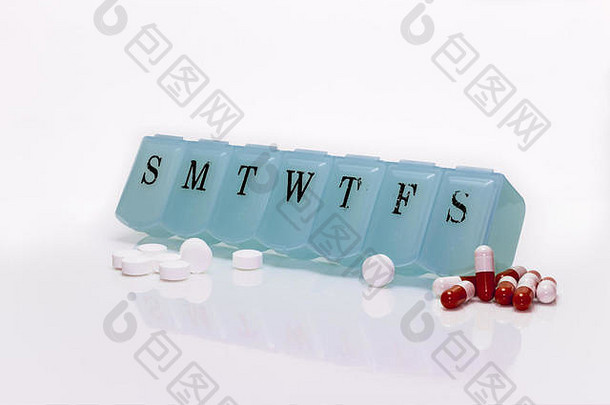 药盒，白色上隔离有多颗药丸。