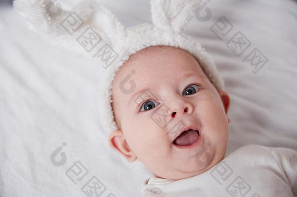 闭合。穿着兔子服微笑的婴儿。