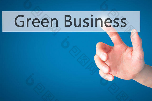 绿色业务-手动按下模糊背景上的按钮。商业、技术、互联网概念。库存照片