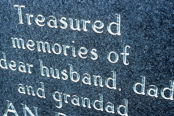 大理石墓碑的细节，刻有<strong>银色字</strong>母，表示对亲爱的丈夫、父亲和祖父的珍贵记忆