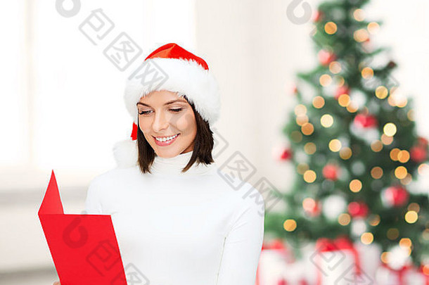 戴着圣诞老人助手帽，带着空白红色明信片的女人