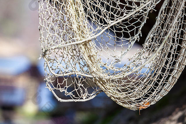 捕鱼设备。老网特写。室外岸边的白色渔网。