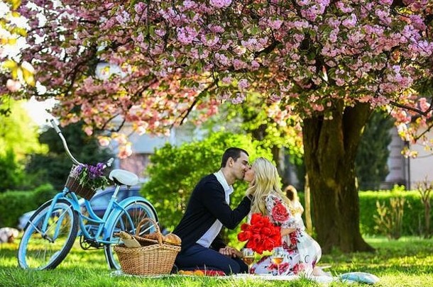 恋人情欲之吻。情侣恋爱野餐<strong>约会</strong>。<strong>春</strong>天的周末。我的宝贝。浪漫的求婚。享受他们完美的<strong>约会</strong>。一对夫妇骑着自行车在公园里放松。带酒的浪漫野餐。