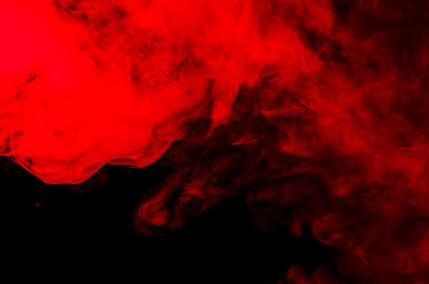 抽象的红色橙色水烟烟在黑色背景上。使用凝胶过滤器拍摄。纹理设计元素。