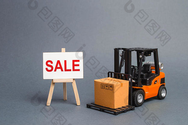 橙色叉车上有一个纸板箱和一个标有“出售”字样的架子。销售增长。本季商品的大折扣。商品
