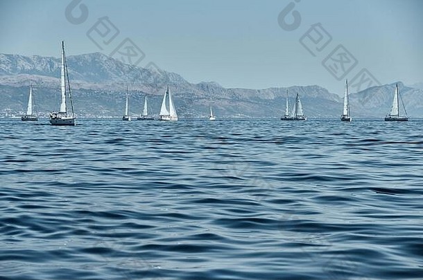 美丽的海景中有帆船，地平线上有帆船比赛，有帆船赛，<strong>竞争激烈</strong>，色彩鲜艳，岛上有风车