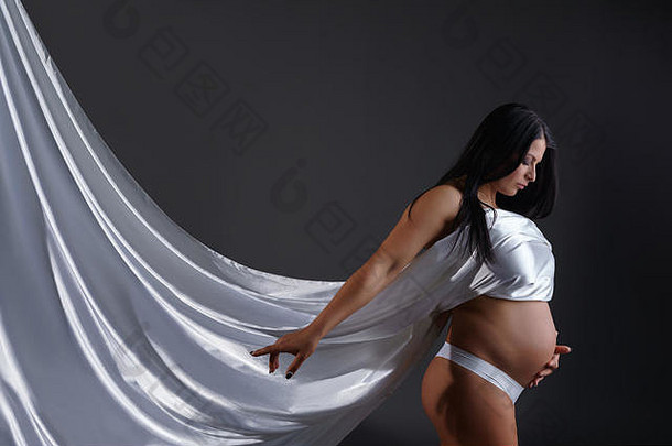照片华丽的怀孕了女人摆姿势丝绸
