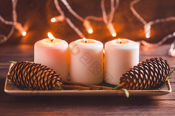 冬天舒适的装饰白色燃烧蜡烛木节日表格罗嗦灯背景温暖的健美的图像