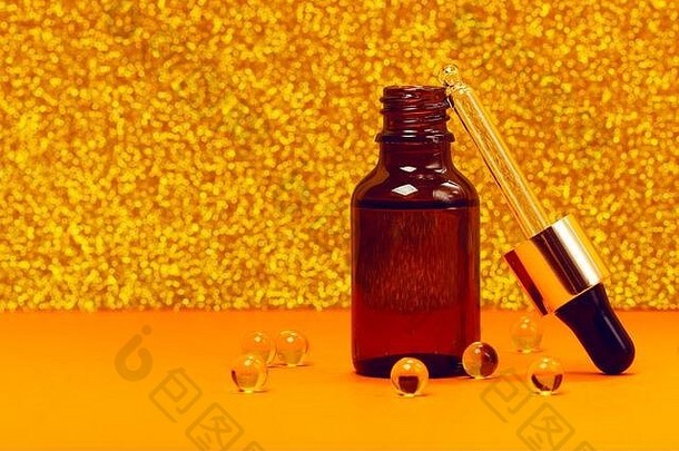 脸血清维生素胶囊时尚的橙色金背景胶原蛋白透明质酸酸皮肤护理成就现代科学化妆品保存美