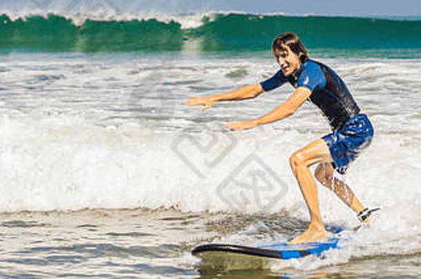 年轻的男人。初学者冲浪者学习冲浪海泡沫巴厘岛岛横幅长格式