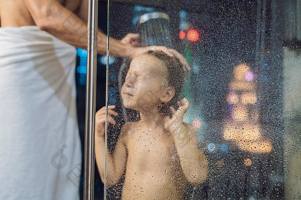 <strong>爸爸</strong>洗儿子的头发淋浴晚上睡眠背景窗口全景视图城市