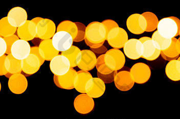 假期发光的黄金背景散焦模糊轮黄色的光圣诞节黑色的背景