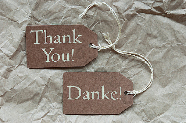 棕色（的）标签标签白色丝带皱巴巴的纸背景德国文本谢谢意味着英语