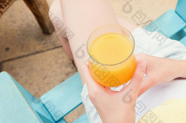 女人手持有玻璃橙色汁