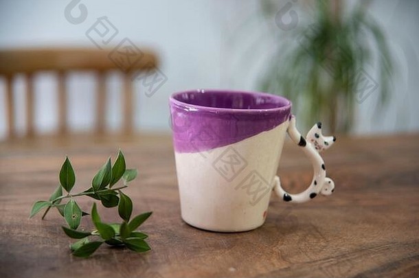 手工制作的色彩斑斓的设计陶瓷咖啡杯木表格