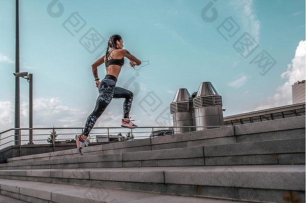 <strong>运动</strong>员女人运行跳体育慢跑培训夏天城市耳机电话概念健身新鲜的空气活跃的生活方式锻炼免费的空间