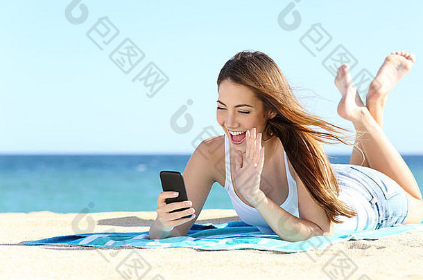 少年女孩挥舞着聪明的电话视频调用假期海背景