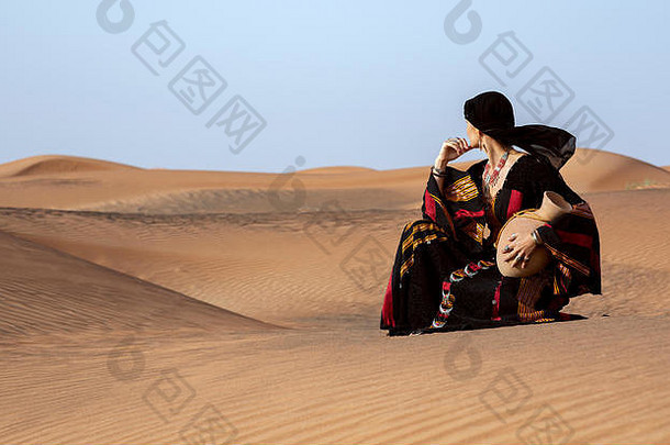 中间岁的女人也门传统的衣服沙漠水菜