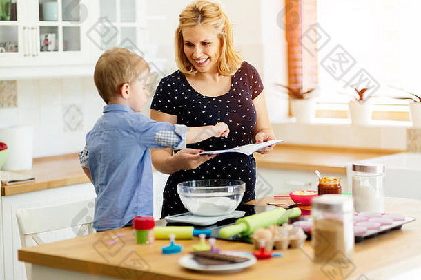 孩子帮助妈妈。准备松饼<strong>厨房</strong>