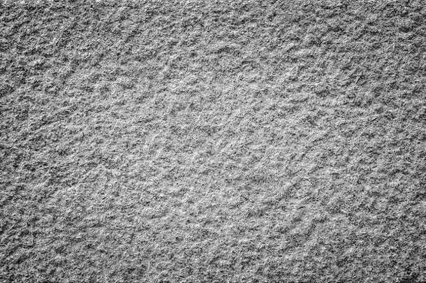 特写镜头崎岖不平的花岗岩石头墙黑色的白色渐晕高决议完整的框架背景纹理