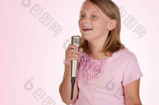 年轻的女孩唱歌卡拉ok孤立的白色