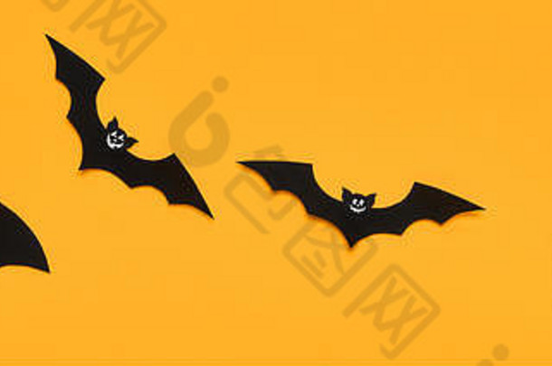 万圣节装饰概念黑色的纸蝙蝠笑脸脸飞行橙色背景万圣节横幅